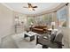 Bright living room features modern decor, a ceiling fan, and natural light from large windows at 4727 Starboard Dr, Bradenton, FL 34208