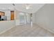 Open-concept living room with tile floors, neutral walls, and a glimpse of modern kitchen appliances at 4727 Starboard Dr, Bradenton, FL 34208