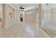 Open-concept living space with tile flooring and a partial view of an adjacent carpeted room at 4727 Starboard Dr, Bradenton, FL 34208