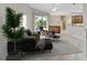 Staged living room with a contemporary sofa, potted plant, and a sliding glass door at 4727 Starboard Dr, Bradenton, FL 34208