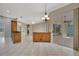 Open living space with tile flooring and wooden bar, providing access to the pool via sliding doors at 4727 Starboard Dr, Bradenton, FL 34208