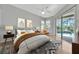 Bright, airy main bedroom with patio access, featuring a ceiling fan and neutral decor at 4727 Starboard Dr, Bradenton, FL 34208