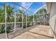 Large screened-in patio area with stone flooring and lush, tropical landscaping at 4727 Starboard Dr, Bradenton, FL 34208