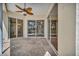 Covered patio featuring decorative concrete flooring and large sliding glass doors at 4727 Starboard Dr, Bradenton, FL 34208