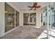 Spacious patio featuring unique stone flooring, a decorative ceiling fan, and views of the outdoors at 4727 Starboard Dr, Bradenton, FL 34208