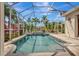 Inviting screened-in pool area with tropical landscaping and clear blue skies at 4727 Starboard Dr, Bradenton, FL 34208