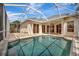 Sparkling screened-in pool with an attached patio and an array of sliding glass doors at 4727 Starboard Dr, Bradenton, FL 34208