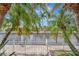 Backyard waterfront view framed by palm trees at 4727 Starboard Dr, Bradenton, FL 34208