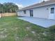 The backyard features a patio, and a well-manicured lawn, enclosed by a wooden fence at 481 Saturn Ave, Sarasota, FL 34243