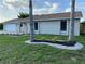 Attractive single-story home with a well-manicured lawn and charming landscaping beds along the front at 481 Saturn Ave, Sarasota, FL 34243