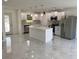 Modern kitchen features white cabinets, marble floors, stainless steel appliances, and a large kitchen island at 481 Saturn Ave, Sarasota, FL 34243