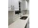 Close-up of a kitchen sink with white countertops and backsplash at 481 Saturn Ave, Sarasota, FL 34243