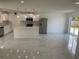 Open kitchen features white cabinets, stainless steel appliances, marble floors, and a large island at 481 Saturn Ave, Sarasota, FL 34243