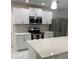 Beautiful kitchen featuring stainless steel appliances, white cabinets and countertops at 481 Saturn Ave, Sarasota, FL 34243