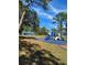 Playground with slides and a covered picnic area surrounded by trees at 481 Saturn Ave, Sarasota, FL 34243
