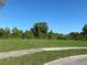 Spacious vacant lot ready for development with lush greenery and mature trees at 481 Saturn Ave, Sarasota, FL 34243