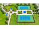 Aerial view of community tennis courts, playground, gazebo, and walking paths surrounded by mature landscaping at 5005 Torrey Pines Run, Bradenton, FL 34211