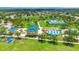 Aerial view of a community park with swimming pools, tennis courts, and recreational areas at 5005 Torrey Pines Run, Bradenton, FL 34211