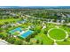 Aerial view of community featuring tennis courts, playground, park, pond, and neighborhood homes with lush landscaping at 5005 Torrey Pines Run, Bradenton, FL 34211