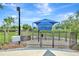 Community dog park features a shaded area and secured fencing at 5005 Torrey Pines Run, Bradenton, FL 34211
