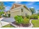 Exterior shot of a well-maintained home with manicured landscaping and a two-car garage at 5005 Torrey Pines Run, Bradenton, FL 34211