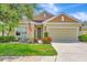 Charming home with a well-manicured lawn, beautiful flowerbeds, and an inviting front entrance at 5005 Torrey Pines Run, Bradenton, FL 34211