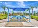 Outdoor picnic area features shaded seating and tropical landscaping at 5005 Torrey Pines Run, Bradenton, FL 34211
