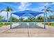Community picnic area featuring covered seating, lush landscaping, and a nearby tennis court for outdoor enjoyment at 5005 Torrey Pines Run, Bradenton, FL 34211