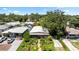 Aerial view showcasing the home's lush front yard, driveway, surrounding landscaping, and neighborhood setting at 5317 14Th S Ave, Gulfport, FL 33707