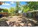Spacious backyard with a wood fence, trees, and leaves covering the ground, perfect for outdoor activities at 5317 14Th S Ave, Gulfport, FL 33707