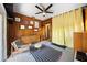 Cozy bonus room with natural light, wood paneling, and colorful rug at 5317 14Th S Ave, Gulfport, FL 33707