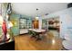 Spacious dining room with vintage furniture, glass shelving, and hardwood floors at 5317 14Th S Ave, Gulfport, FL 33707