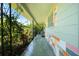 Spacious front porch featuring lush greenery and colorful brick accents at 5317 14Th S Ave, Gulfport, FL 33707