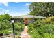 Charming home featuring an orange door and lush garden, a serene entrance at 5317 14Th S Ave, Gulfport, FL 33707