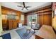 Cozy, paneled living room with built-in shelving, ceiling fan, and sliding glass doors to the yard at 5317 14Th S Ave, Gulfport, FL 33707