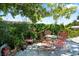Cozy outdoor patio featuring whimsical metal furniture set amidst vibrant greenery and brick accents at 5317 14Th S Ave, Gulfport, FL 33707