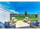 Inviting back patio with comfortable seating, perfect for relaxing with views of the serene lake at 5711 Archipelago St, Nokomis, FL 34275