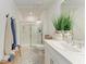 Bright bathroom features a glass-enclosed shower, modern vanity, and ample lighting at 5711 Archipelago St, Nokomis, FL 34275
