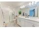 Bright bathroom features a dual vanity, large mirror, and a glass-enclosed shower at 5711 Archipelago St, Nokomis, FL 34275