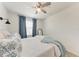 Bright bedroom has a queen sized bed and large window with fashionable blue curtains at 5711 Archipelago St, Nokomis, FL 34275
