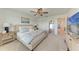 Bright bedroom with a ceiling fan, comfy bed, and ample lighting, creating a warm ambiance at 5711 Archipelago St, Nokomis, FL 34275