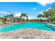 Resort-style pool with turquoise water, abundant seating, and a shady cabana for relaxation at 5711 Archipelago St, Nokomis, FL 34275
