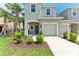 Charming two-story townhome with a one car garage, landscaping, and a welcoming front entrance at 5711 Archipelago St, Nokomis, FL 34275