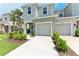 Two-story home showcasing an attached garage, lush lawn, and a welcoming entrance at 5711 Archipelago St, Nokomis, FL 34275