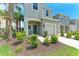 Inviting two-story townhome with manicured landscaping, a blue front door, and attached garage at 5711 Archipelago St, Nokomis, FL 34275