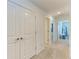 Upstairs hallway features closet and views into bedrooms with stylish decor and lighting at 5711 Archipelago St, Nokomis, FL 34275