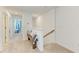 Bright hallway features carpet and a decorative wooden bench with stylish pillows at 5711 Archipelago St, Nokomis, FL 34275