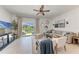 Bright living room with stylish furniture, neutral decor, and sliding glass doors to an outdoor patio at 5711 Archipelago St, Nokomis, FL 34275