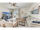 Cozy living room with neutral decor, ceiling fan, and stylish furniture with a view of the backyard at 5711 Archipelago St, Nokomis, FL 34275