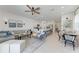 Open-concept living space featuring modern furniture, an island kitchen, and plenty of natural light at 5711 Archipelago St, Nokomis, FL 34275